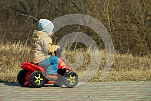 Little boy on an electric Quad bike in the Park