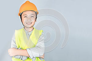 Little boy in engineering uniform with helmet and copy space