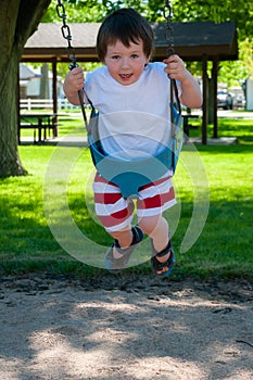 A Little boy enjoying his day at the city park