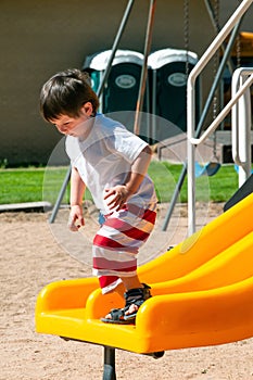 A Little boy enjoying his day at the city park