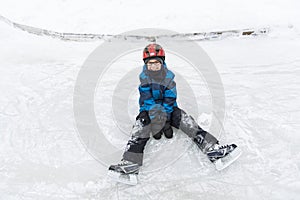 Little boy enjoying ice skating in winter season