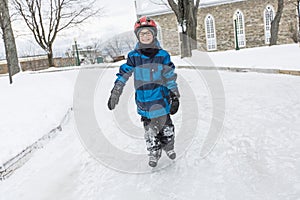 Little boy enjoying ice skating in winter season