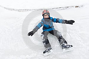 Little boy enjoying ice skating in winter season