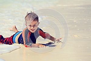 Little boy enjoying sea on beach vacation