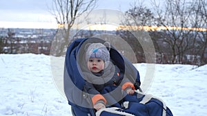 Little boy enjoying a sleigh ride