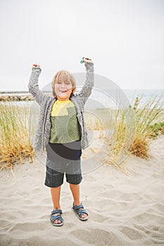 Little boy enjoying summer vacation by the sea