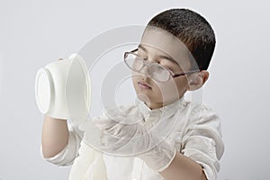 A little boy experimenting with liquids at home