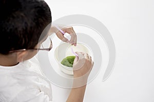 A little boy experimenting with liquids at home