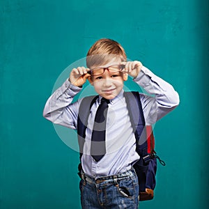 little Boy in eyeglasses with big backpack