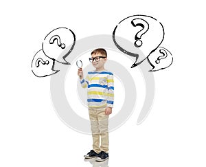 Little boy in eyeglasses with magnifying glass