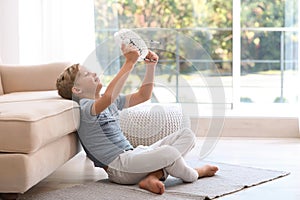 Little boy with fan relaxing at home