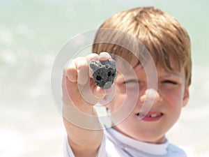 Little boy finding shells