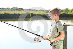 Little boy fishing alone