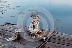 Little boy fishing at sunset