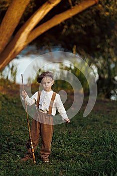 Little boy fishing at sunset