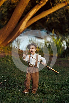 Little boy fishing at sunset