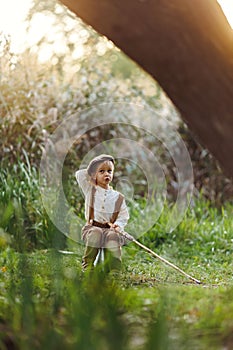 Little boy fishing at sunset