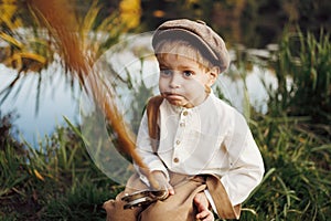 Little boy fishing at sunset