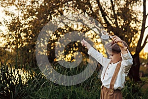 Little boy fishing at sunset