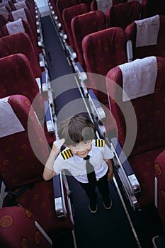 Little boy in flight attendant costume gives a salute