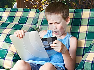 Little boy with floppy disk and tablet pc