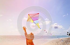 Little boy flying a kite on tropical beach