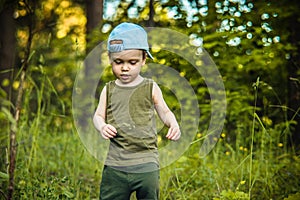 Little boy in a forest hiking
