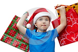 Little boy in fur-cap with shopping bags. Christmas