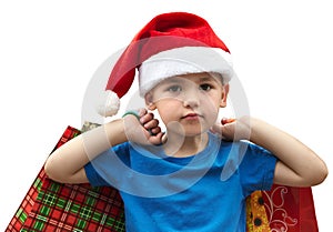 Little boy in fur-cap with shopping bags. Christmas