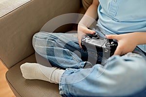Little boy with gamepad playing video game at home