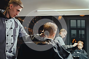 Little Boy Getting Haircut By Barber