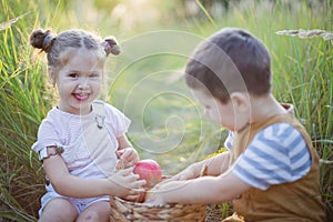Little boy and girl with basket of apples