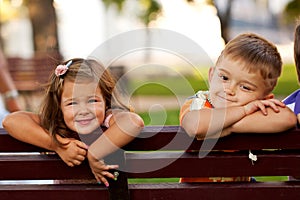 Little boy and girl on a bench