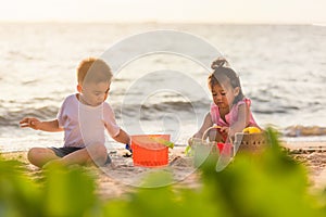 Little boy and girl brother and sister family playing sand