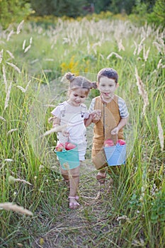 Little boy and girl with bucket of apples