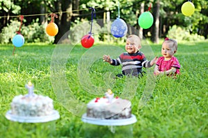 little boy and girl celebrating their first