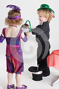 Little boy and girl in costume magicians shows