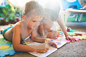 Little boy and girl drawing with crayons