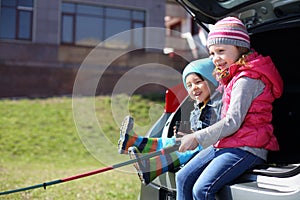 Little boy and girl with fishing rod playing in