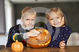 Little boy and girl with halloween pumpkin