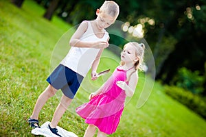 Little boy and girl with ladybird in park