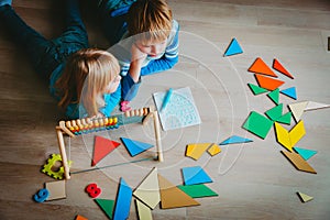 Little boy and girl learn to write and calculate numbers