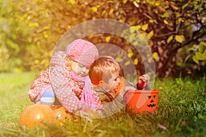 Little boy and girl play with autumn leaves in nature