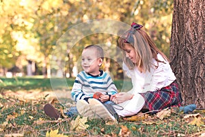 Little boy and a girl are playing outdoor