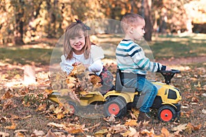 Little boy and a girl are playing outside