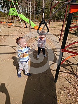Little boy and girl playing on a playground