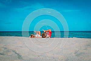 Little boy and girl relax on tropical beach
