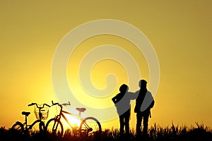 Little boy and girl riding bikes at sunset, active kids sport, A