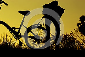 Little boy and girl riding bikes at sunset, active kids sport, Asian kid,Silhouette a kid at the sunset, Happy time.