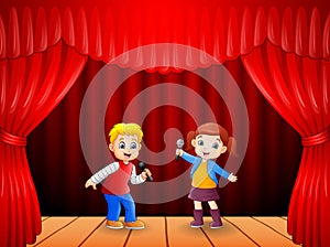 Little boy and girl singing with microphone in his hand